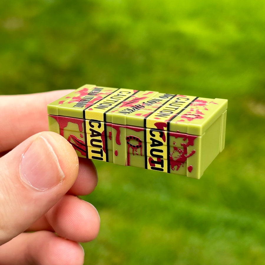 Zombie Head Crate in Olive Green by BrickTactical, closed crate in hand